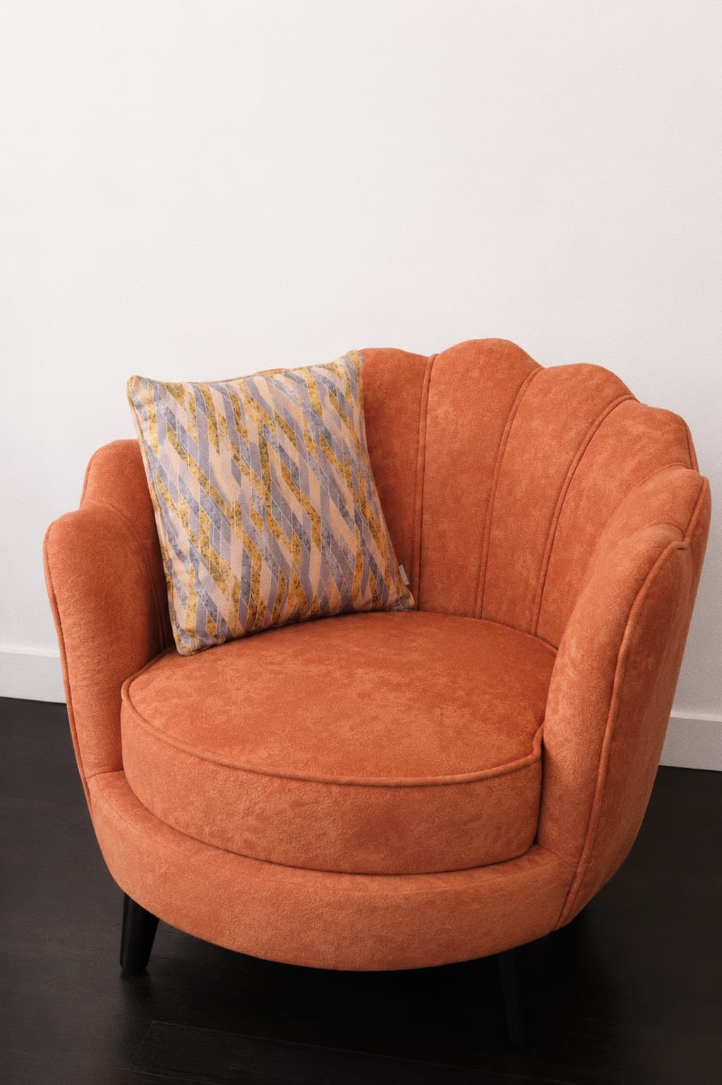 Burnt-orange scalloped velvet accent chair with patterned cushion by NDB.