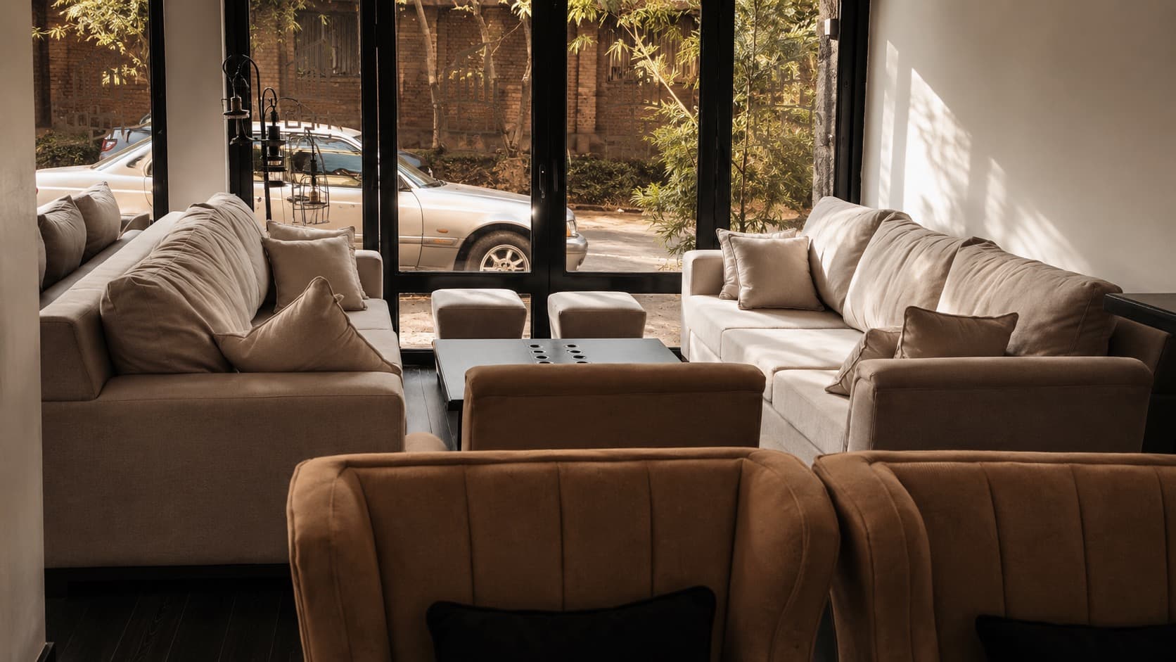 NDB sofa suites arranged along the showroom glazing with the Kigali street beyond.