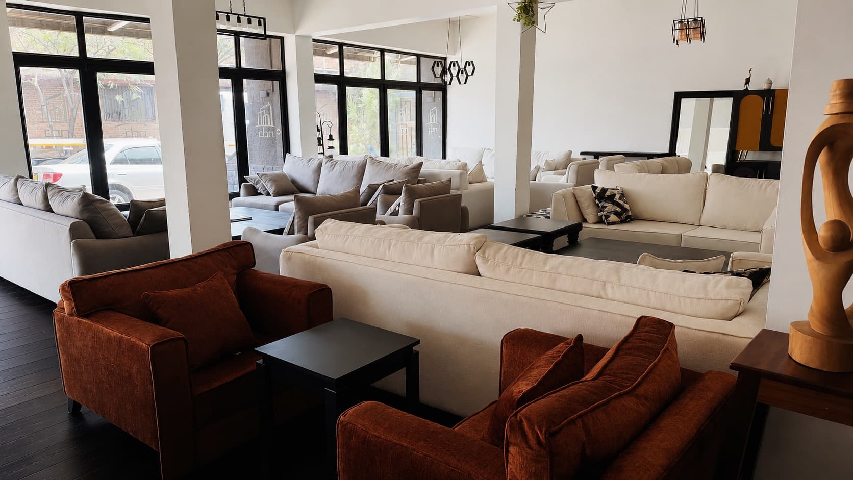 Wide view of the NDB showroom in Kigali, with seating suites arranged between columns and glazing.